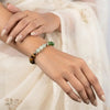 Woman wearing a multicolor beaded bracelet with natural gemstone beads, elegant ethnic outfit