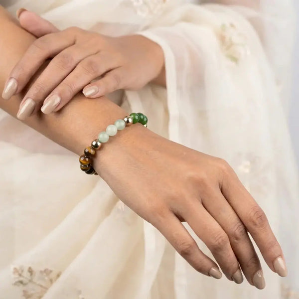 Woman wearing a multicolor beaded bracelet with natural gemstone beads, elegant ethnic outfit