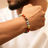 Man wearing a multicolor beaded gemstone bracelet on wrist