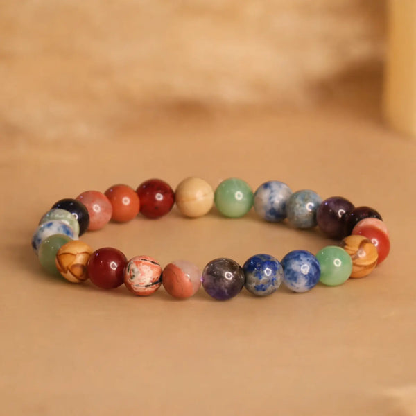 Multi-colored natural stone beaded bracelet on a neutral background