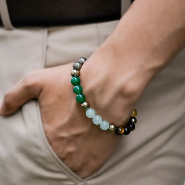 Hand wearing a multicolor gemstone beaded bracelet, earthy tones, casual style