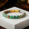 multicolor gemstone beaded bracelet with green, gold, yellow, and clear crystal beads on white box