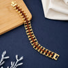Gold plated Rudraksha bead bracelet on dark textured surface